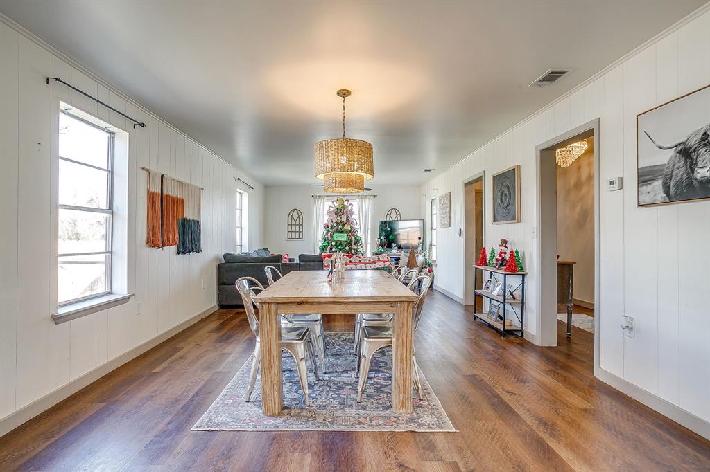 610 North Mesquite Hico, TX 76457 - Photo 12 of 34 Dining room featuring dark wood-style flooring and wooden walls