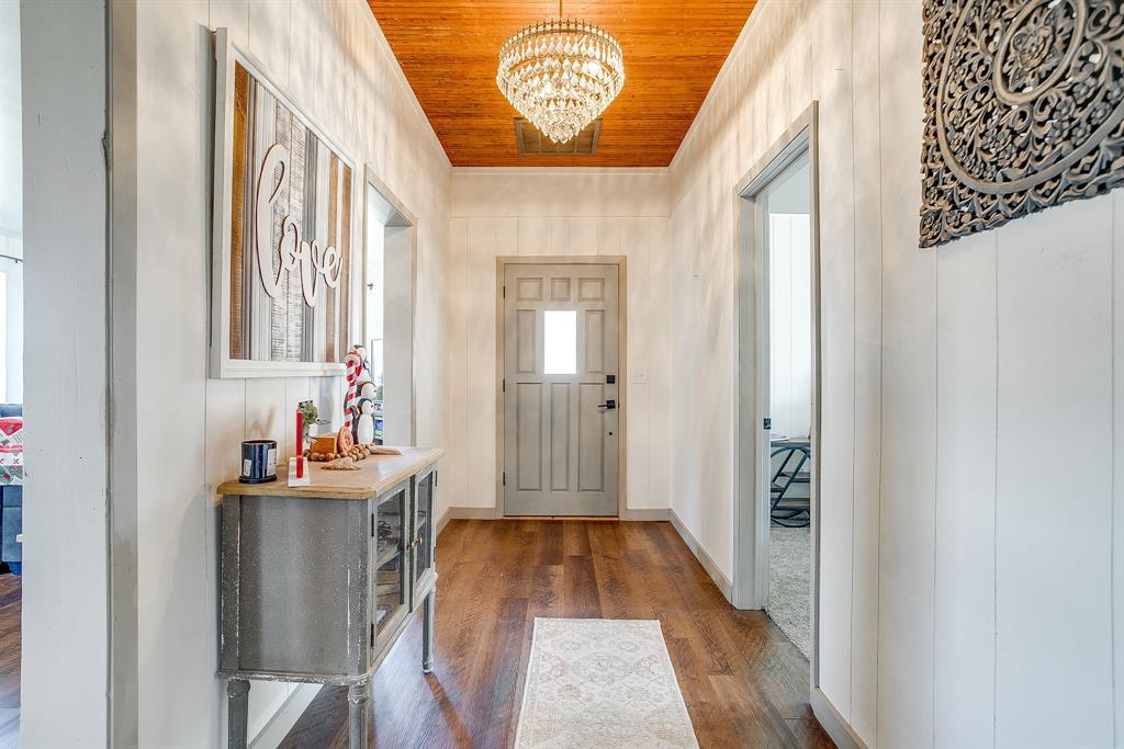 610 North Mesquite Hico, TX 76457 - Photo 4 of 34 Entrance foyer featuring wood ceiling, dark wood-type flooring, and a chandelier