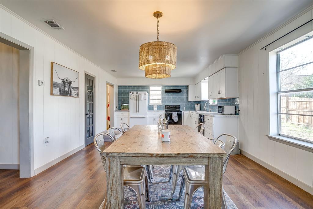 610 North Mesquite Hico, TX 76457 - Photo 9 of 34 Dining room with wood walls, dark wood finished floors, and a chandelier