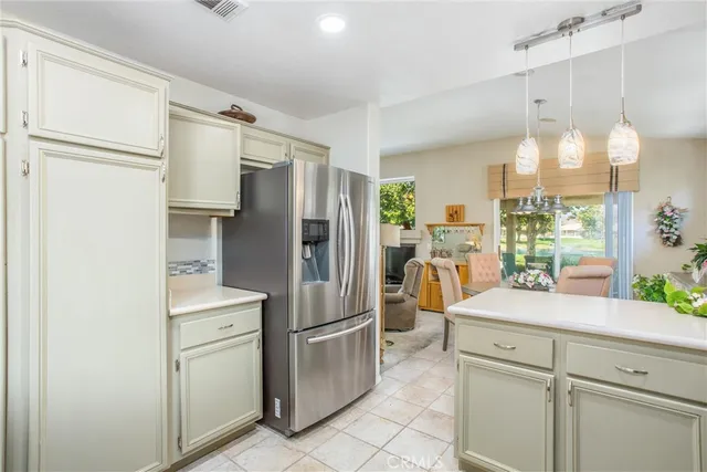 a kitchen with refrigerator and cabinets