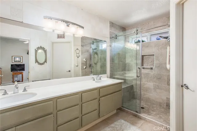 a bathroom with a shower sink and mirror
