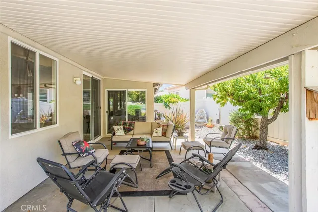 a living room with furniture and floor to ceiling windows