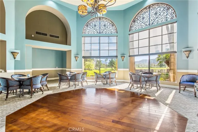 an outdoor space with lots of furniture and a chandelier