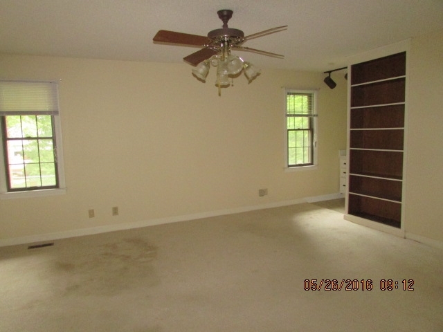 5835 Huddersfield Road Macon, GA 31210 - Photo 18 of 19 an empty room with chandelier fan and windows