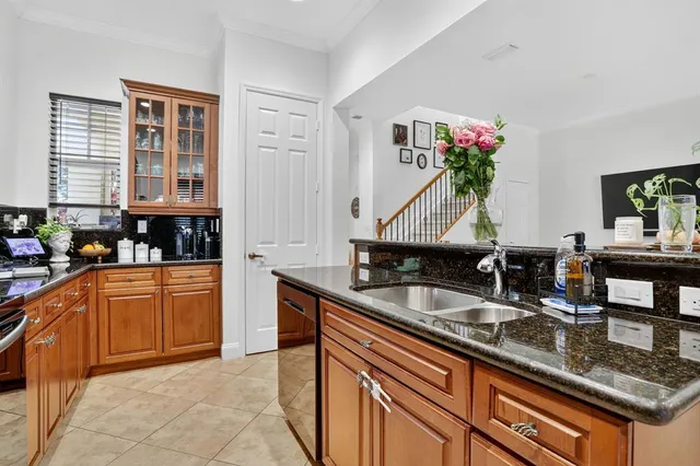 a kitchen with granite countertop a sink and cabinets