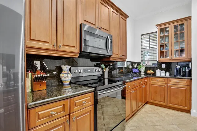 a kitchen with stainless steel appliances granite countertop a stove a sink and dishwasher