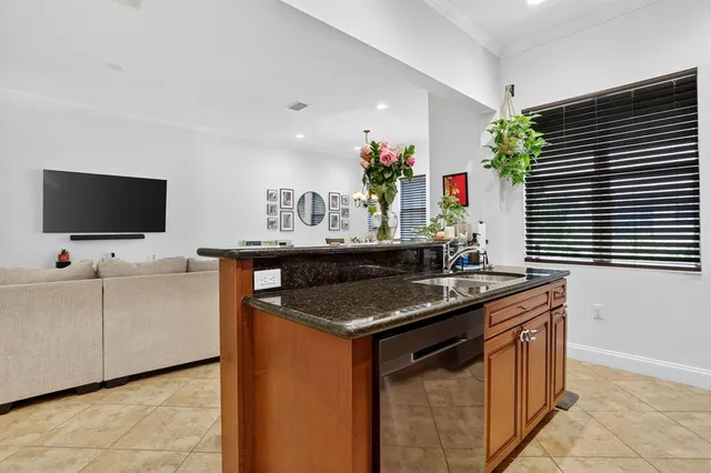 a kitchen with stainless steel appliances granite countertop a sink stove and cabinets