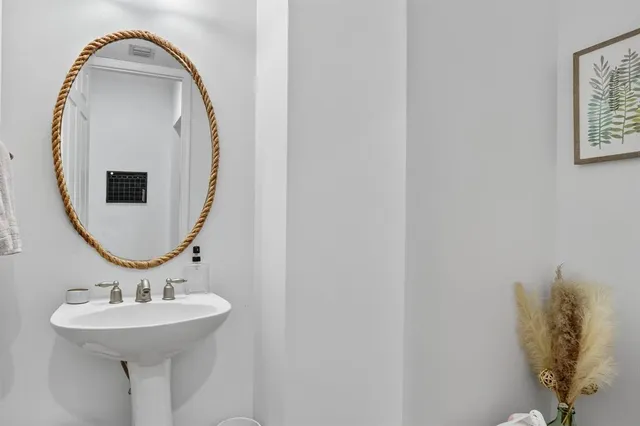 a bathroom with a sink and mirror