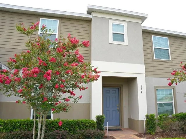 a flower plants in front of a house