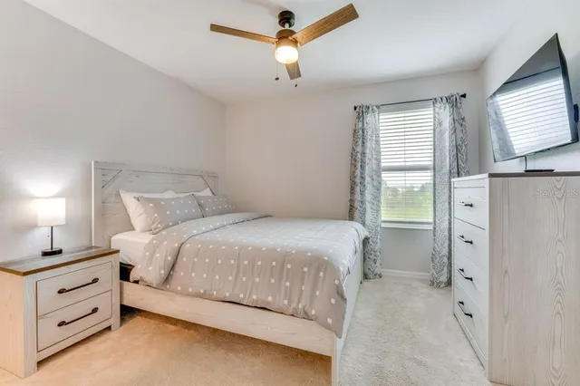 a bedroom with a bed and a window