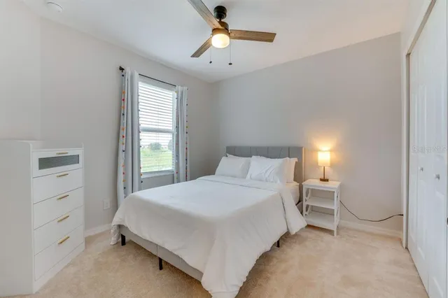 a bedroom with a bed and a window