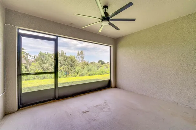 an empty room with windows and pool table