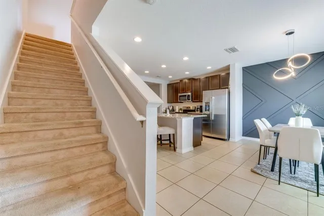 a view of kitchen with furniture and refrigerator
