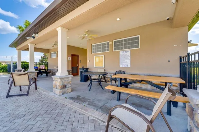 a living room with patio furniture and a wooden floor