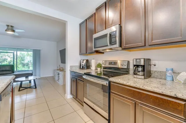 a kitchen with stainless steel appliances granite countertop a sink and a stove