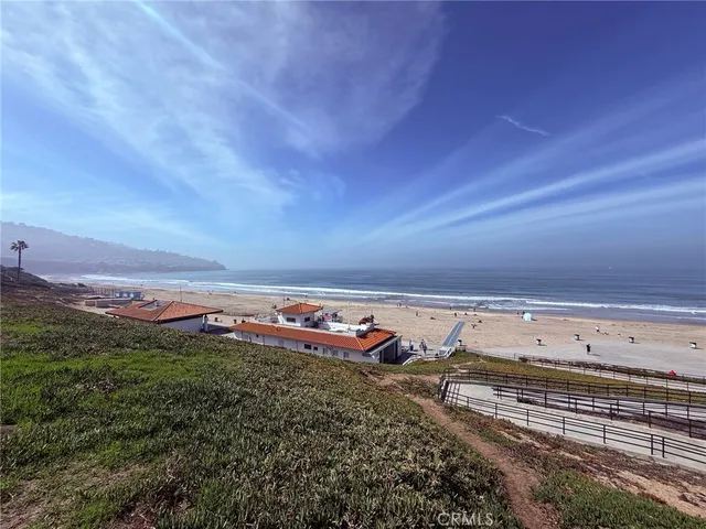 a view of a field with an trees in the background
