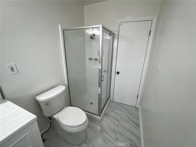 a bathroom with a toilet and a shower