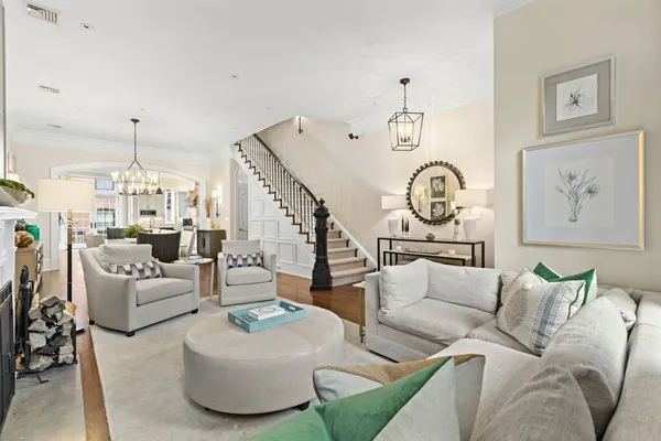 a living room with furniture a rug and a chandelier