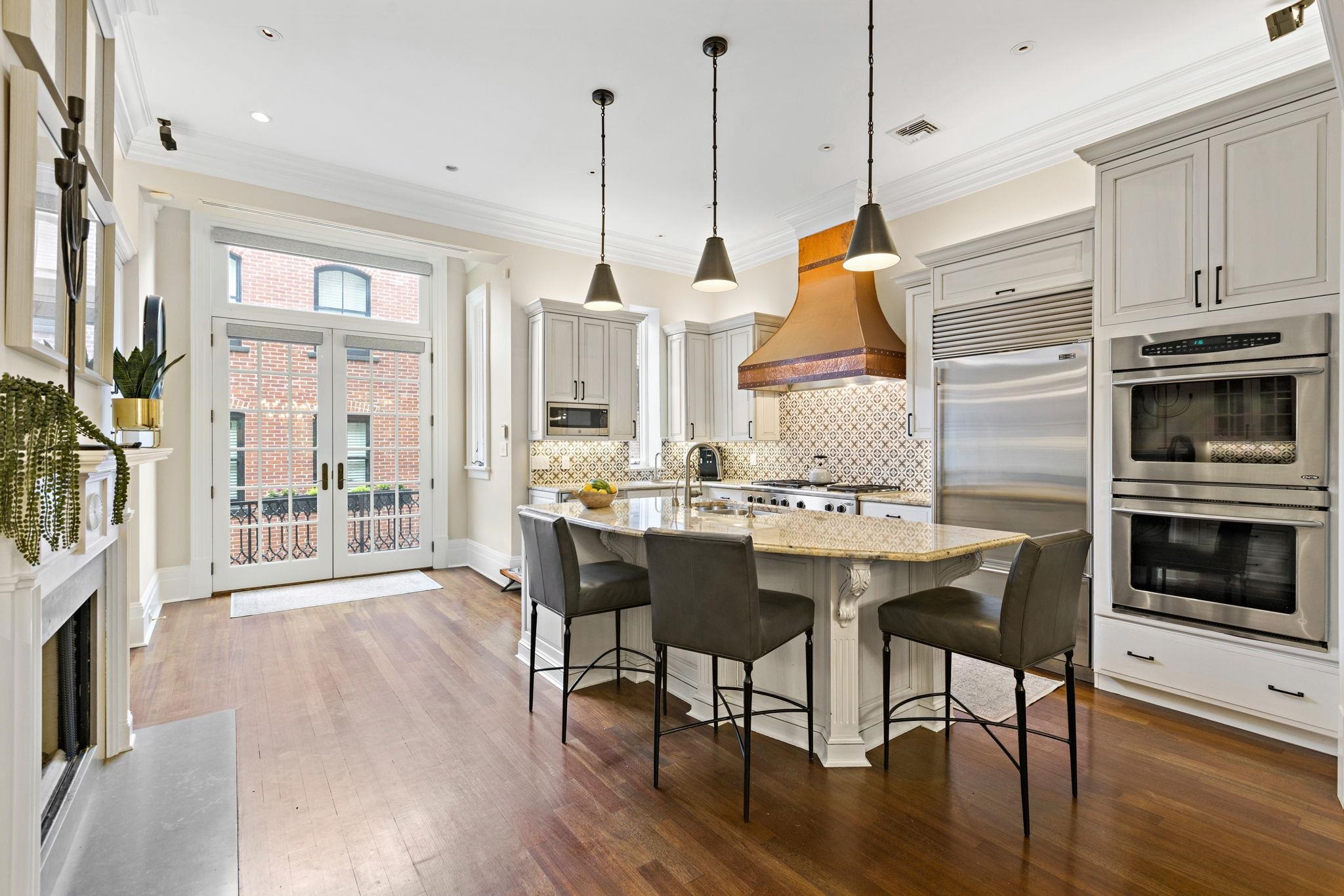 630 Hudson Street Hoboken, NJ 07030 - Photo 14 of 50 a kitchen with stainless steel appliances granite countertop a kitchen island hardwood floor and a sink