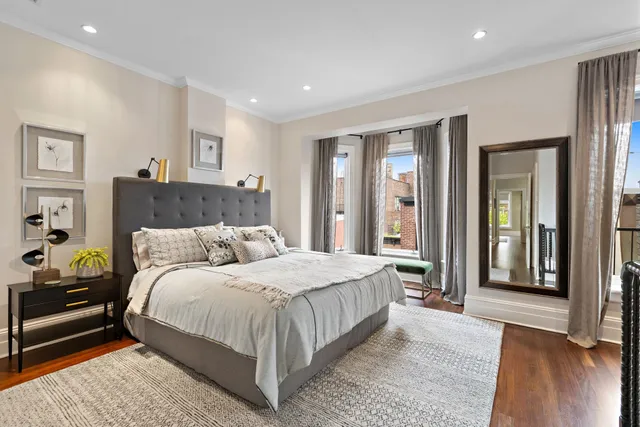 a bedroom with a large bed and a chandelier