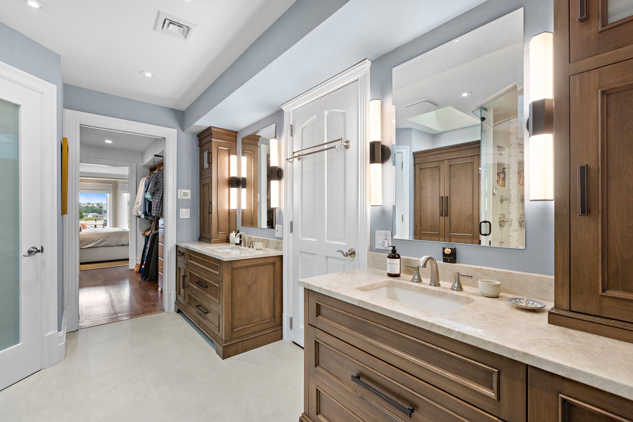 630 Hudson Street Hoboken, NJ 07030 - Photo 32 of 50 a spacious bathroom with a double vanity sink a mirror and a bathtub