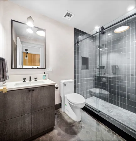 a bathroom with a sink toilet and shower