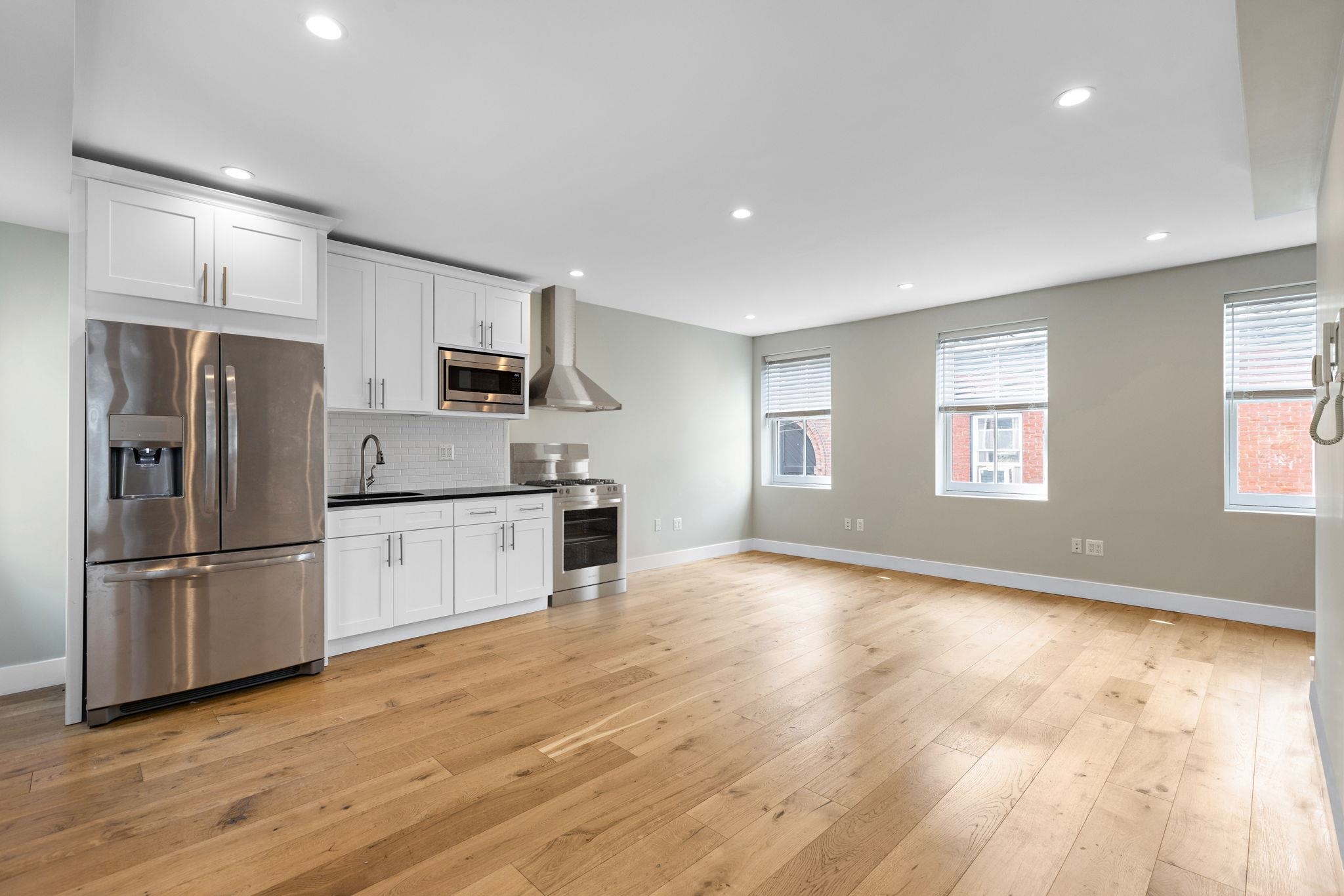 630 Hudson Street Hoboken, NJ 07030 - Photo 48 of 50 a kitchen with stainless steel appliances a refrigerator sink and microwave