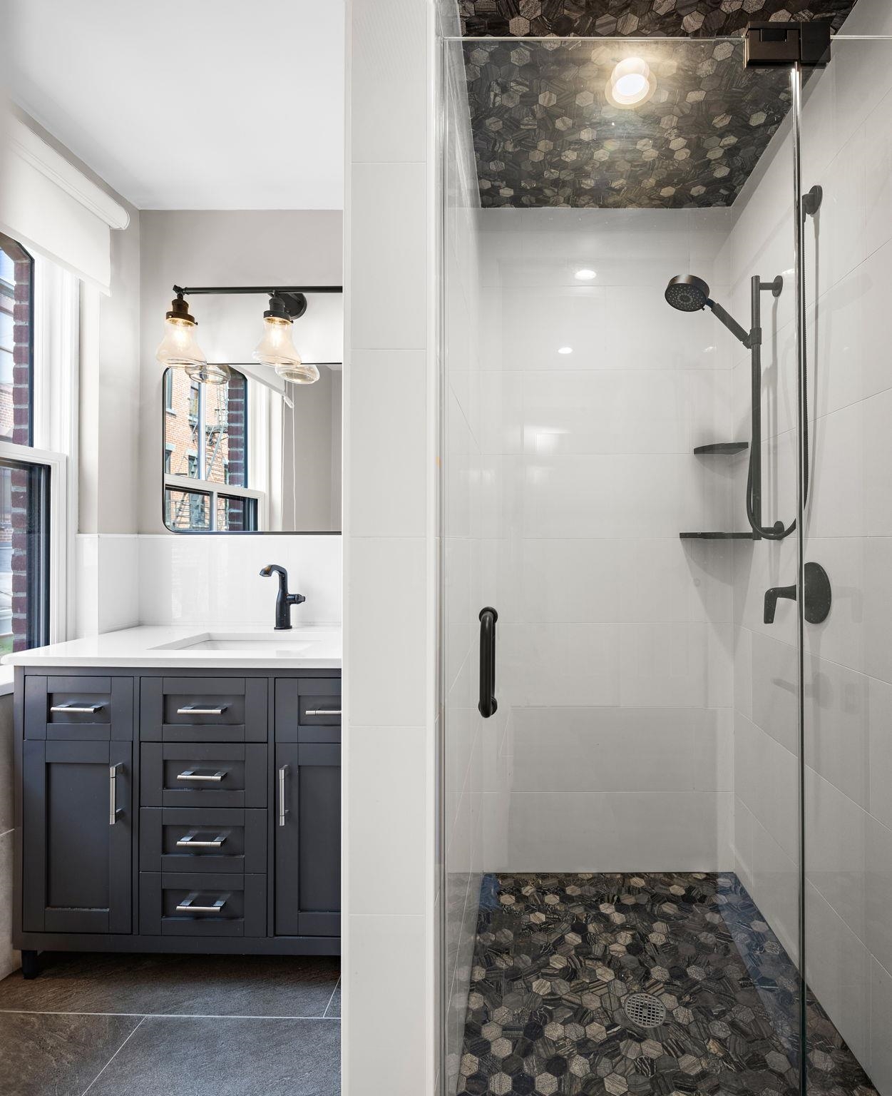 630 Hudson Street Hoboken, NJ 07030 - Photo 50 of 50 a bathroom with a sink and a mirror
