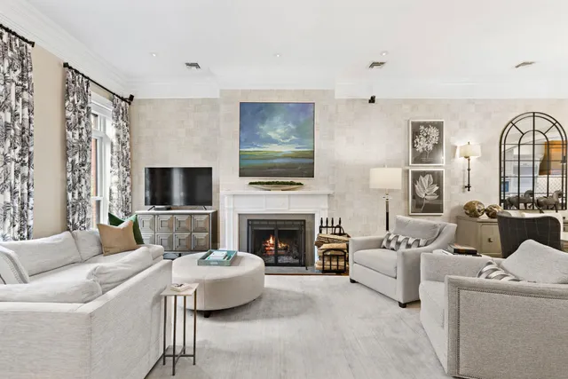 a living room with furniture a fireplace and a flat screen tv