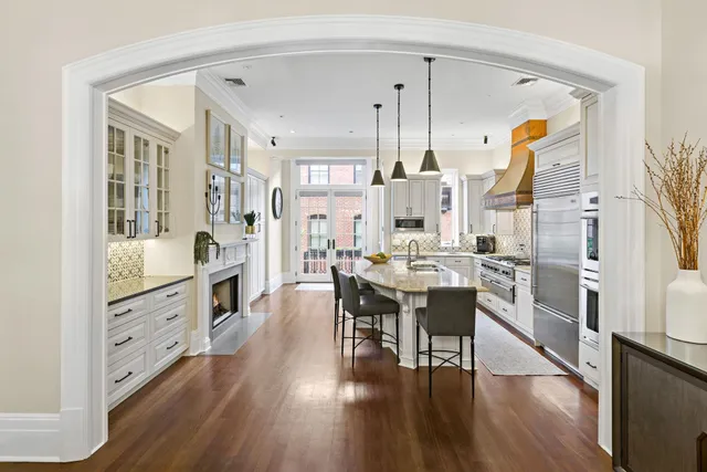a large kitchen with a table and chairs