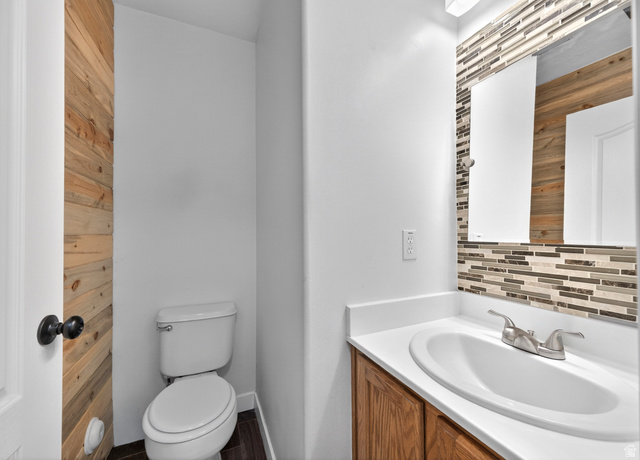 802 Sugar Maple Court Payson, UT 84651 - Photo 11 of 30 Half bath with vanity and decorative backsplash