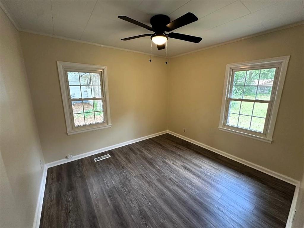 121 Hunt Drive Calhoun, GA 30701 - Photo 11 of 20 an empty room with wooden floor ceiling fan and windows