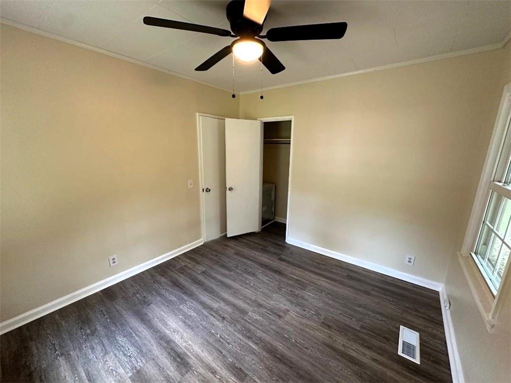 121 Hunt Drive Calhoun, GA 30701 - Photo 12 of 20 an empty room with wooden floor ceiling fan and windows