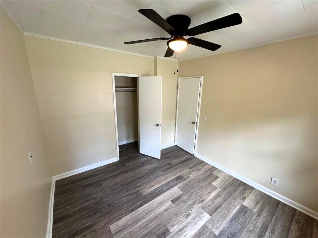 121 Hunt Drive Calhoun, GA 30701 - Photo 14 of 20 an empty room with wooden floor a ceiling fan and carpet