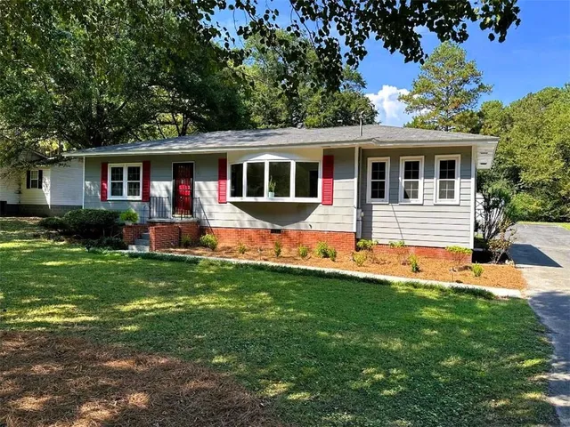 a front view of house with yard and green space