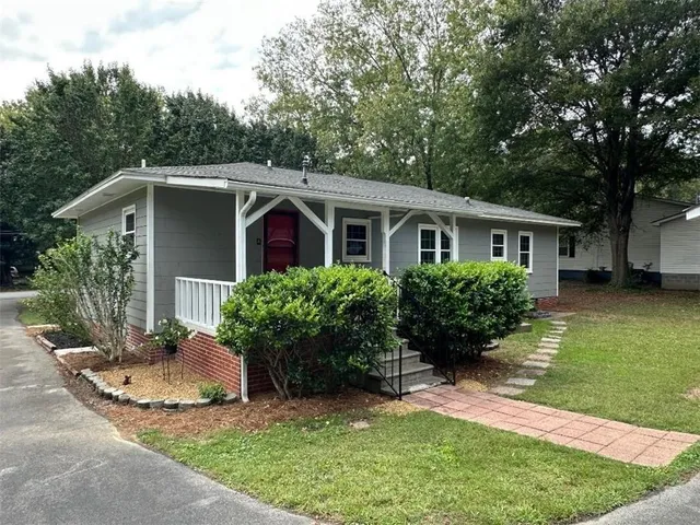 a front view of a house with a garden