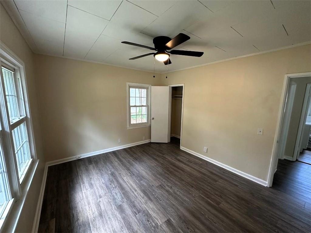 121 Hunt Drive Calhoun, GA 30701 - Photo 9 of 20 an empty room with wooden floor fan and windows