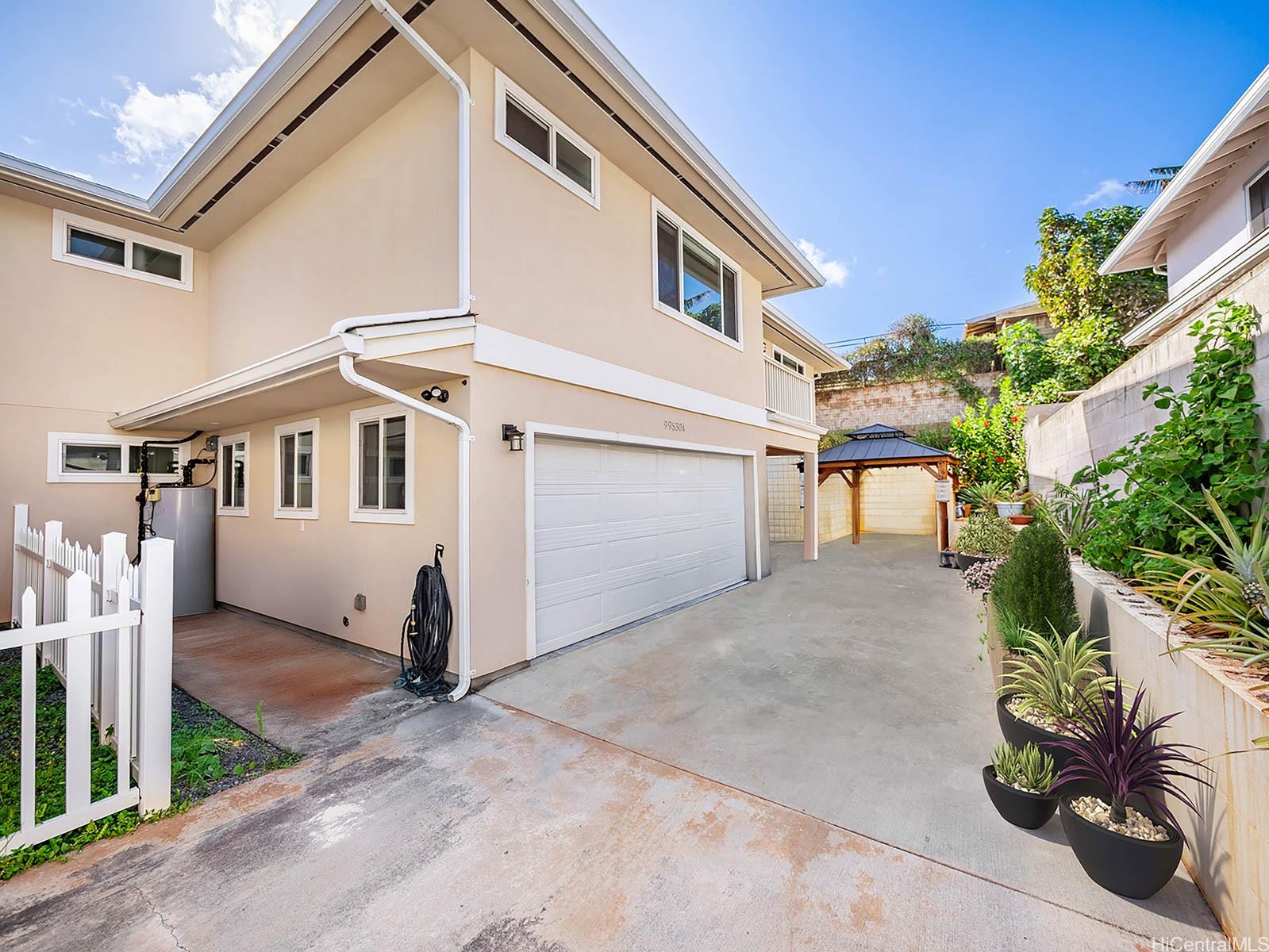 99-530 Halawa Heights Road, Unit A Aiea, HI 96701 - Photo 1 of 1 a view of a white house with a yard and potted plants