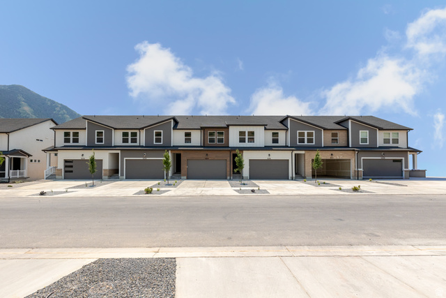 5228 South Acacia Drive, Unit 808 Mapleton, UT 84664 - Photo 2 of 22 Modern townhome exteriors featuring multi-toned siding, dark roofs, and individual garage entrances
