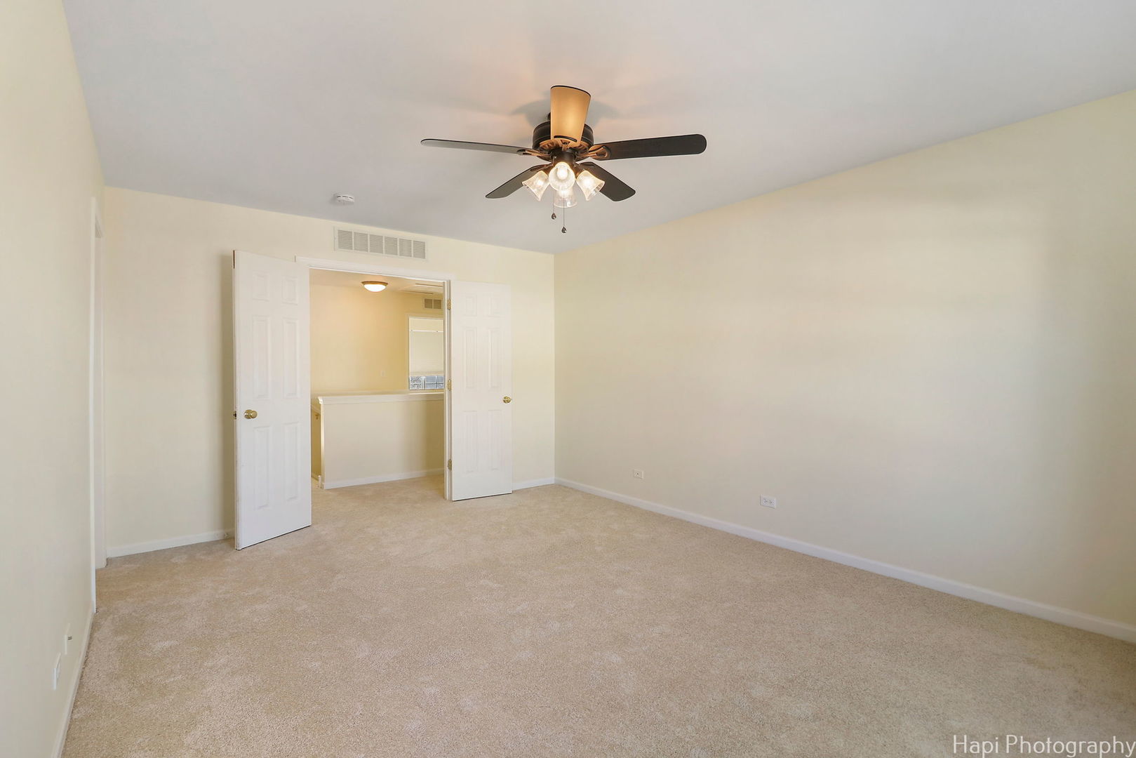 5332 Wildspring Drive, Unit 5332 Lake In The Hills, IL 60156 - Photo 14 of 29 wooden floor in an empty room and a chandelier fan