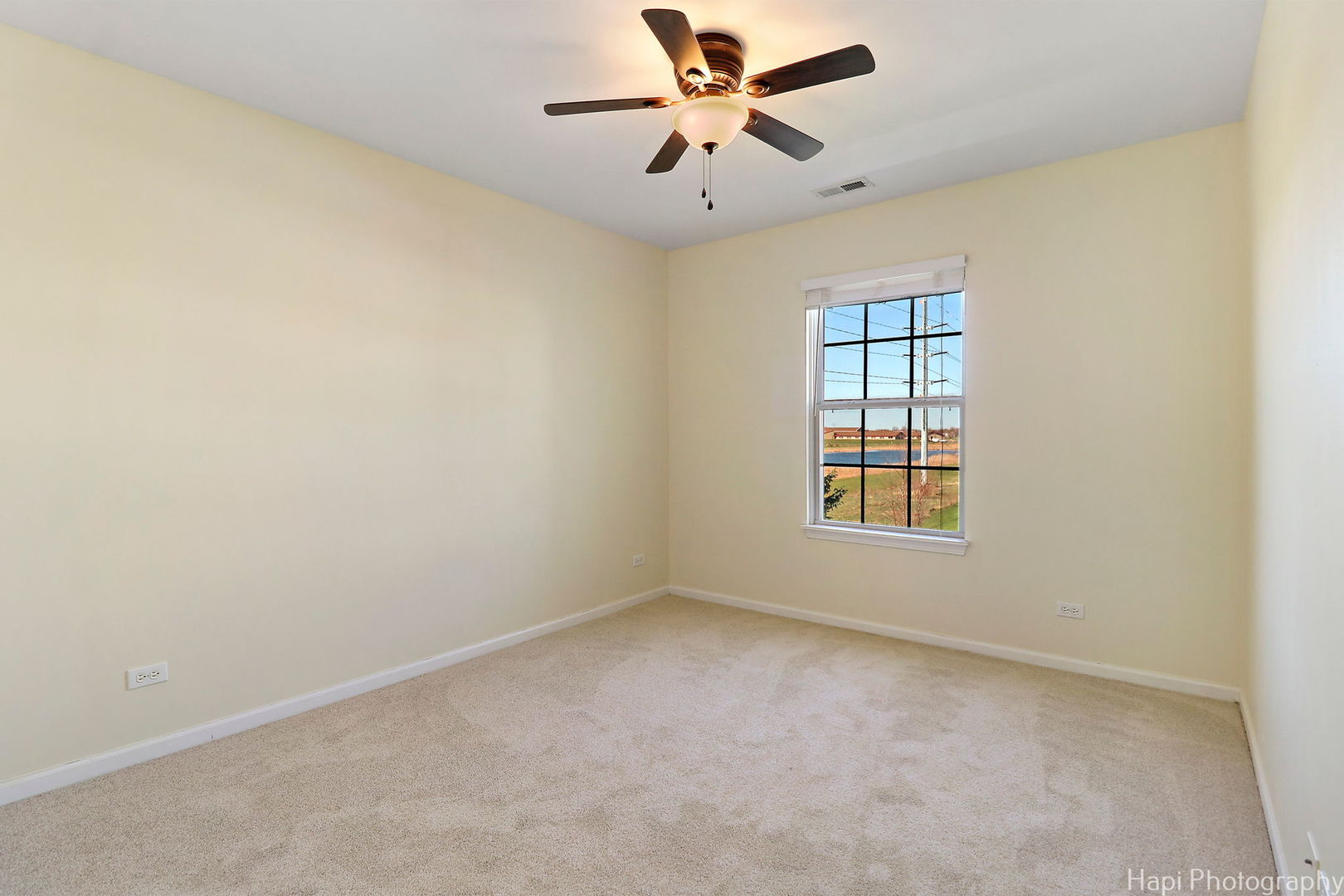 5332 Wildspring Drive, Unit 5332 Lake In The Hills, IL 60156 - Photo 16 of 29 an empty room with a window and a fan
