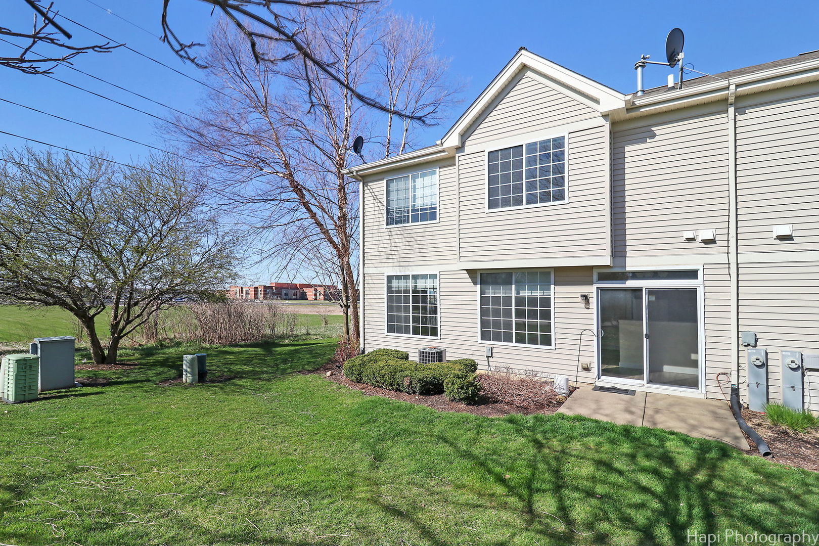 5332 Wildspring Drive, Unit 5332 Lake In The Hills, IL 60156 - Photo 25 of 29 a front view of a house with a yard and outdoor seating