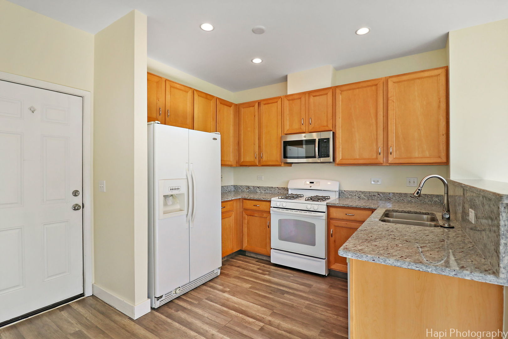 5332 Wildspring Drive, Unit 5332 Lake In The Hills, IL 60156 - Photo 7 of 29 a kitchen with stainless steel appliances granite countertop a refrigerator stove and sink