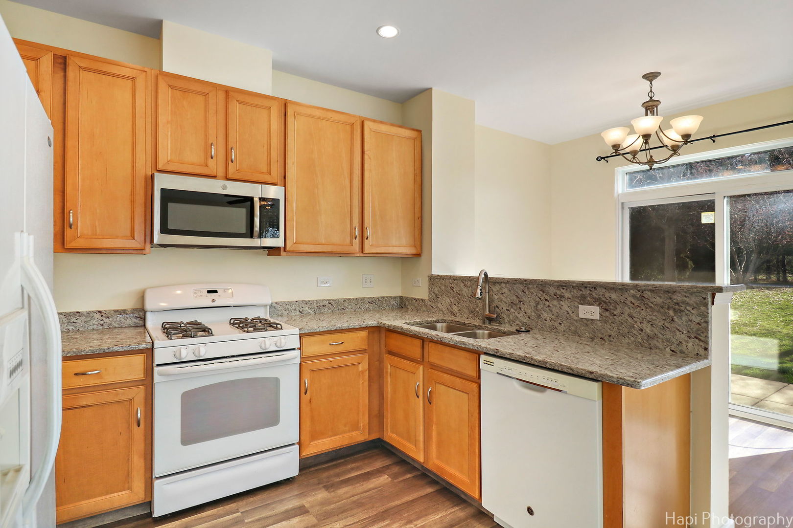 5332 Wildspring Drive, Unit 5332 Lake In The Hills, IL 60156 - Photo 9 of 29 a kitchen with a sink stove and microwave