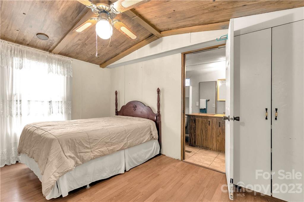 853 Enon Church Road Blacksburg, SC 29702 - Photo 15 of 29 a bedroom with a bed and a chandelier