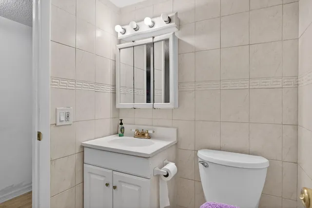 a bathroom with a sink a toilet and mirror