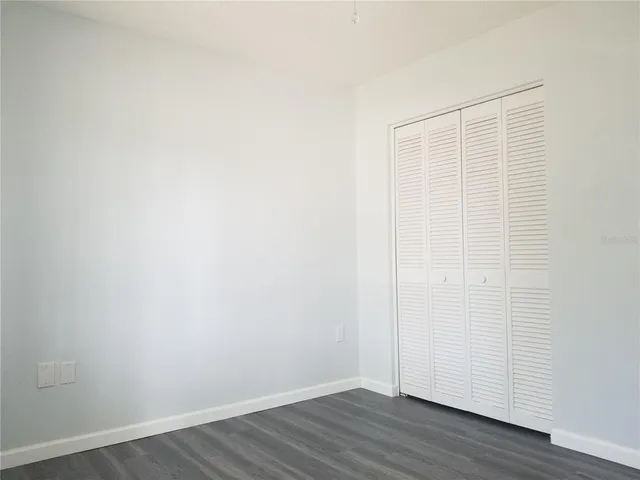 a bathroom with a granite countertop toilet and a sink