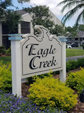 a street sign that is sitting in front of flowers