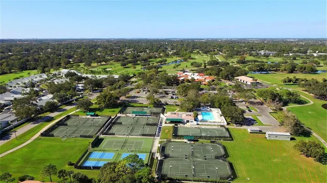 an aerial view of a house with a garden and lake view