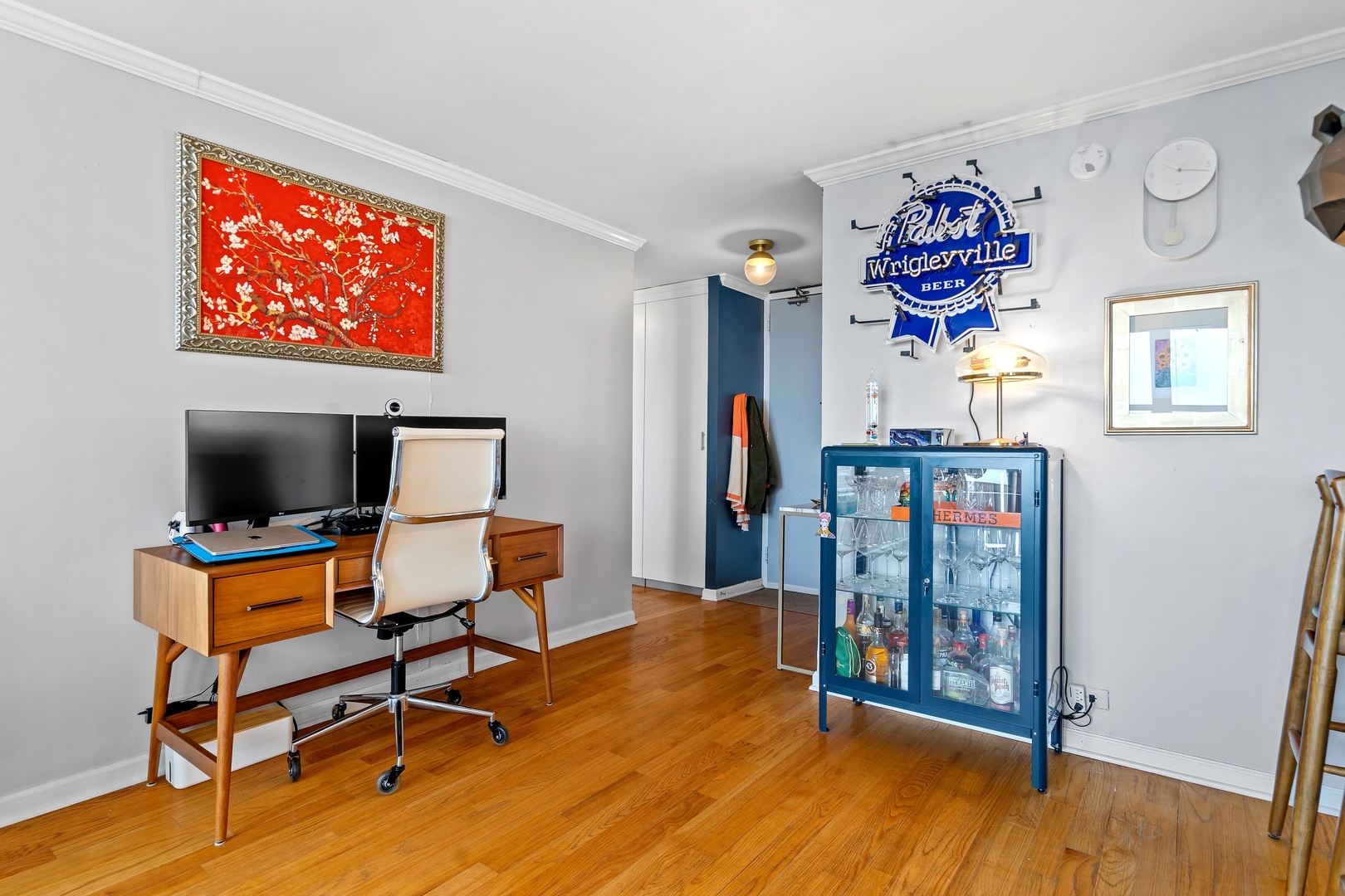 655 West Irving Park Road, Unit 3608 Chicago, IL 60613 - Photo 14 of 37 a workspace with furniture wooden floor and a flat screen tv